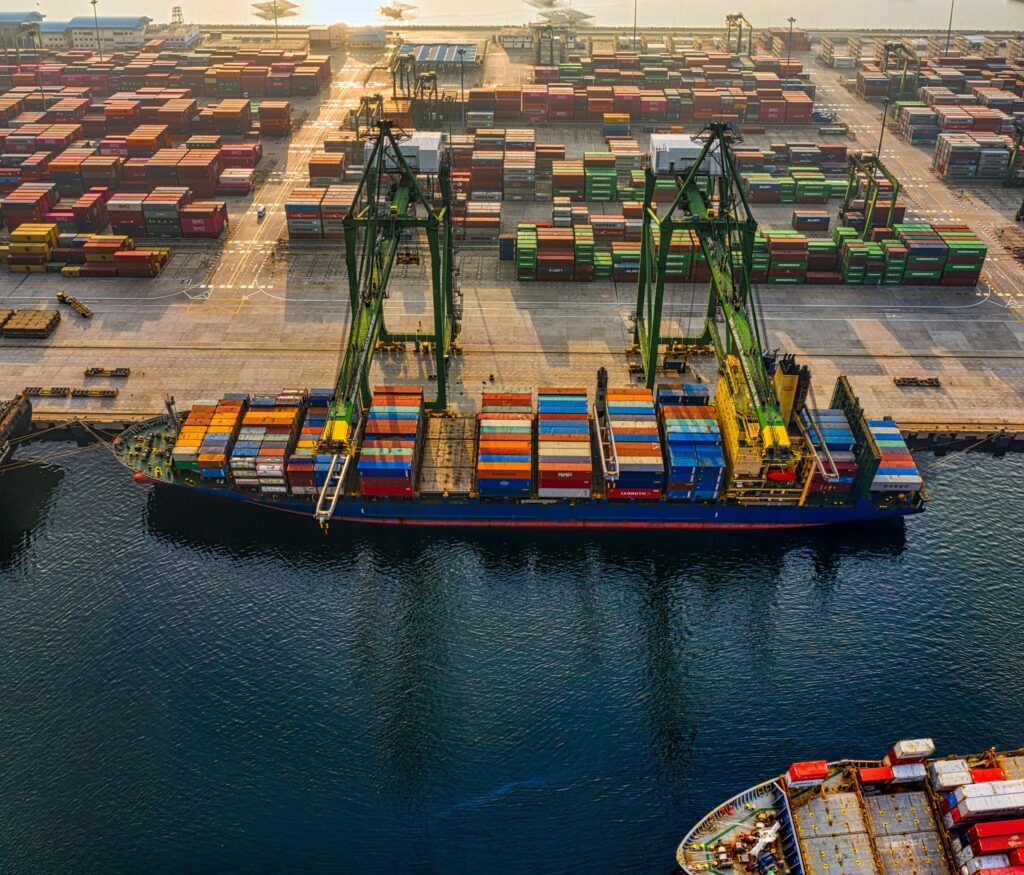 Aerial shot of colorful shipping containers at North Jakarta's bustling port, Indonesia.